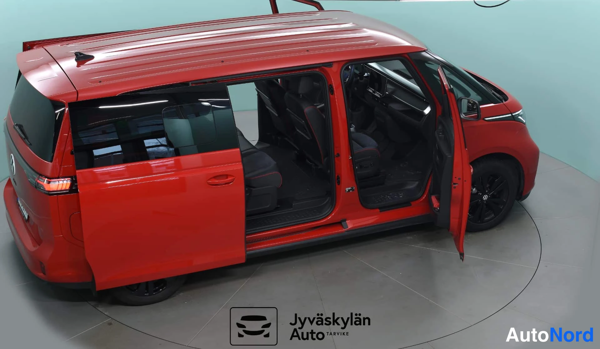 Red Volkswagen ID. Buzz 2025, front three-quarter, nose to the right, photo 4